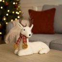 Ver imagem 2 de Rena Decorativa Natalina em Pelúcia Creme Deitada com Cachecol Xadrez Vermelho e Marrom 24x27cm