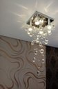 Ver imagem 2 de Lustre de Cristal para Sala com 70cm de altura e base de inox espelhado de 20x20cm