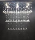 Ver imagem 3 de LUSTRE DE CRISTAL PARA SALA DE JANTAR/ESTAR COM 90CM DE ALTURA, BASE DE INOX ESPELHADO COM 70X20CM