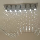 Ver imagem 2 de Lustre de Cristal para sala de jantar com 65cm de altura e base de inox espelhado de 70x18cm e 07 lâ
