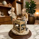 Ver imagem 2 de Escultura Decorativa em Porcelana a Menina e o Sapateiro 28X26X26cm