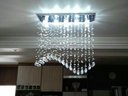 Ver imagem 1 de Lustre Onda em Cristais Mesa de Jantar Base 70x20:base Inox Espelhada/0,50 Cm/110v/220v (bivolt)
